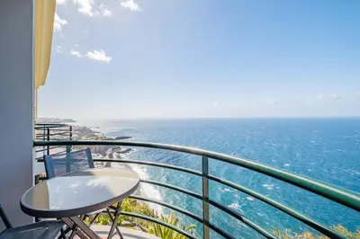 a balcony with a view of the ocean at Sea View - By WeHost in Câmara de Lobos