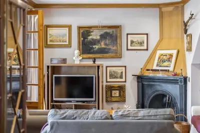 a living room with a tv and a fireplace at Vila Botânica - By WeHost in Funchal