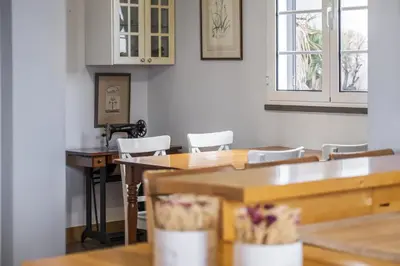 a kitchen with a table and chairs and a sink at Vila Botânica - By WeHost in Funchal