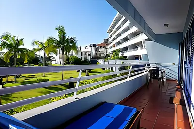 a balcony with a blue bench and a view of the ocean at Your Home In Madeira III in Funchal