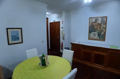 a dining room with a yellow table and white chairs at Your Home In Madeira III in Funchal