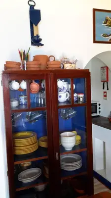 a cabinet full of plates and bowls and dishes at Casa da Fajãzinha in Vila do Porto