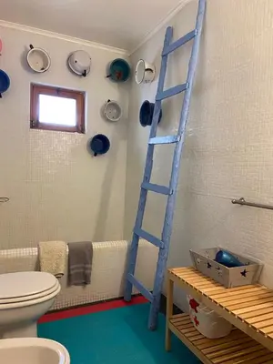 a blue ladder in a bathroom with a toilet at Casa Pedralva in Vila do Bispo