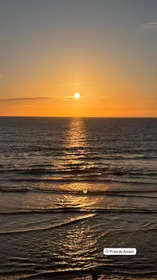 a sunset over the ocean with the sun setting at Casa Pedralva in Vila do Bispo