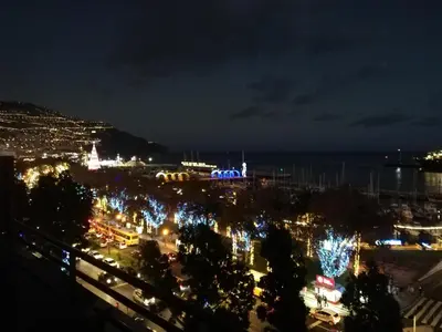 a view of a city at night with lights at Marina Club Apartment in Funchal