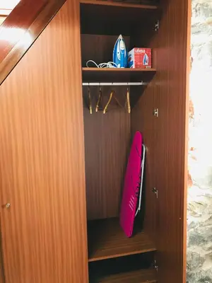 a wooden closet with a pink pillow in it at Casa do Lugar da Ribeira in Ribeira Brava