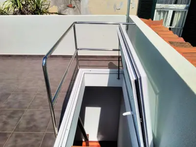 a glass stair case on a building with stairs at Casa do Lugar da Ribeira in Ribeira Brava
