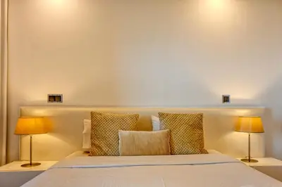 a bedroom with a bed with two lamps at Seculo XXI-U, a Home in Madeira in Funchal