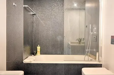 a bathroom with a shower and a tub and a toilet at Seculo XXI-U, a Home in Madeira in Funchal
