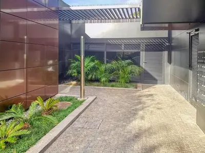 an internal courtyard of a house with palm trees at Seculo XXI-U, a Home in Madeira in Funchal