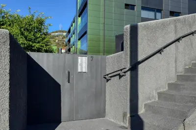 a concrete wall with stairs next to a building at Seculo XXI-U, a Home in Madeira in Funchal