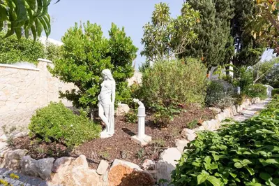 a statue of a woman in a garden at CoolHouses Algarve, Casa Redonda, V3 Lagos in Lagos