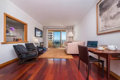 a living room with a table and a desk at Falesia Apartment by LovelyStay in Funchal