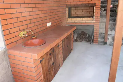 a brick wall with a sink and a fireplace at Casa da Fininha in Calheta