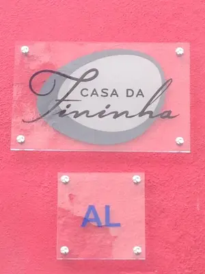 a sign that says casa da mimosa on a pink wall at Casa da Fininha in Calheta