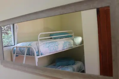 a mirror reflection of a bunk bed in a room at Casa da Fininha in Calheta