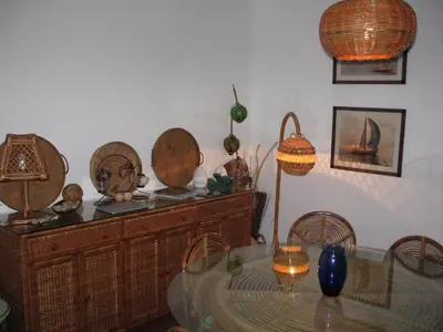 a dining room with a glass table and some baskets at Villa Ines, at the beach in Porto Santo