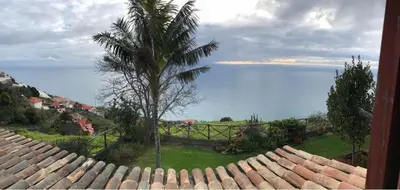 a view of the ocean from the roof of a house at CASA DOS FALCÕES casa rural de construção tradicional in Fajã da Ovelha
