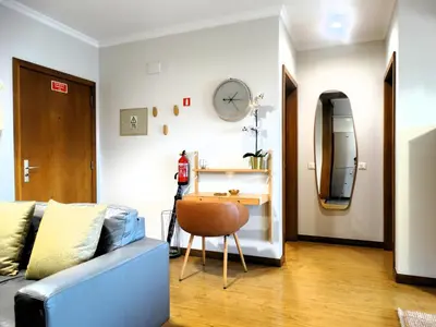 a living room with a couch and a table and a tv at AP Charme Anadia in Funchal