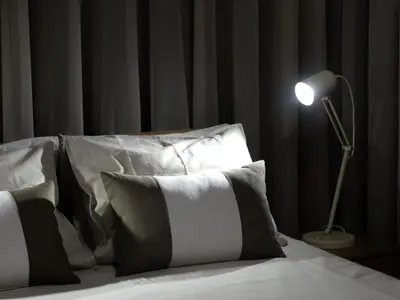 a bedroom with a bed with black curtains and two lamps at AP Charme Anadia in Funchal