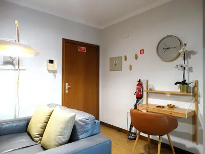 a living room with a couch and a table at AP Charme Anadia in Funchal