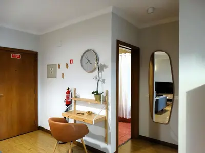a living room with a desk and a chair at AP Charme Anadia in Funchal