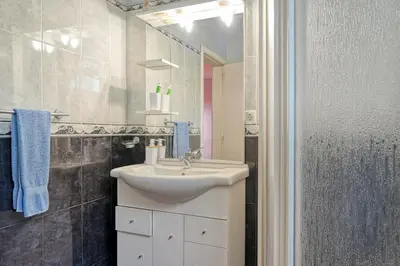 a bathroom with a sink and a shower at Casa do Pombal, a Home in Madeira in Arco da Calheta