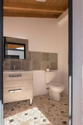 a kitchen with white cabinets and a black counter top at Villa Guiné in Arco da Calheta