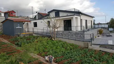 a house with a garden in front of it at Villa Guiné in Arco da Calheta