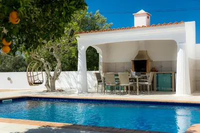 a patio with a table and chairs next to a swimming pool at Casa Luisandra Boutique Hotel B&B in Luz