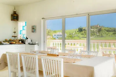 a kitchen and dining room with a table and chairs at Casa Luisandra Boutique Hotel B&B in Luz