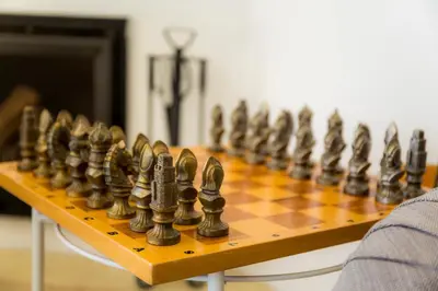 a chessboard is lined up on a wooden table at Casa Luisandra Boutique Hotel B&B in Luz