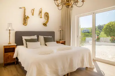 a bedroom with a large white bed with a window at Casa Luisandra Boutique Hotel B&B in Luz