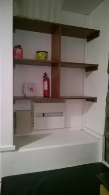 a kitchen with white walls and wooden shelves at Central Suite in Funchal 1N in Funchal