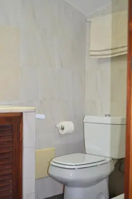 a bathroom with a white toilet and a sink at Central Suite in Funchal 1N in Funchal