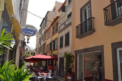 a street with tables and chairs and a building at Central Suite in Funchal 1N in Funchal