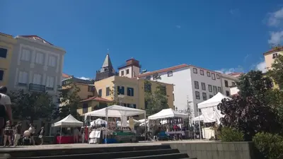 a street market with white umbrellas in a city at Central Suite in Funchal 1N in Funchal