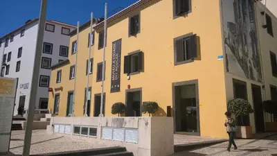 a person walking in front of a yellow building at Central Suite in Funchal 2N in Funchal