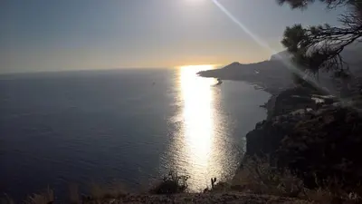a view of the ocean at sunset from a cliff at Central Suite in Funchal 2N in Funchal