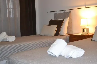 a hotel room with two beds with white towels at Central Suite in Funchal 2N in Funchal