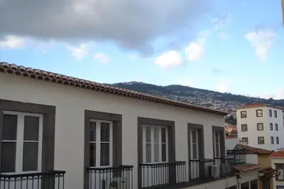 a row of houses with mountains in the background at Central Suite in Funchal 3N in Funchal