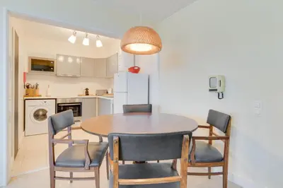 a kitchen and dining room with a table and chairs at Funchal Marina Bay in Funchal