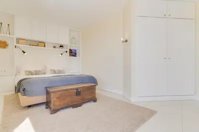 a bedroom with a bed and a wooden table at Funchal Marina Bay in Funchal