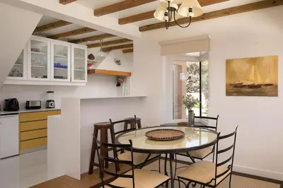 a kitchen and dining room with a table and chairs at Porto Moniz Villa in Porto Moniz