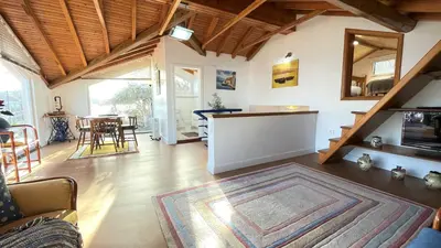 a living room with a couch and a table at Porto Moniz Villa in Porto Moniz