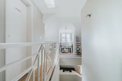 a white room with a staircase and a sink at Mansarda dos Aranhas by Madeira Best Apartments in Funchal
