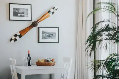a room with a table and a baseballophone on the wall at Mansarda dos Aranhas by Madeira Best Apartments in Funchal