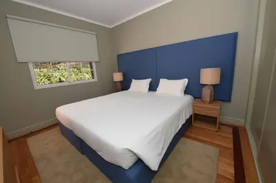a bedroom with a large bed with a blue headboard at Villa Chaves in Funchal