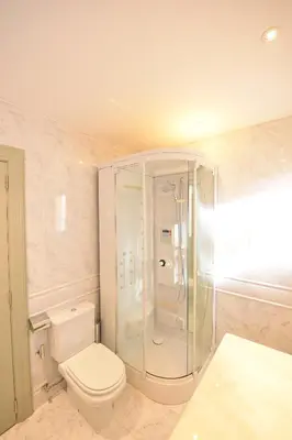 a bathroom with a toilet and a glass shower at Villa Chaves in Funchal