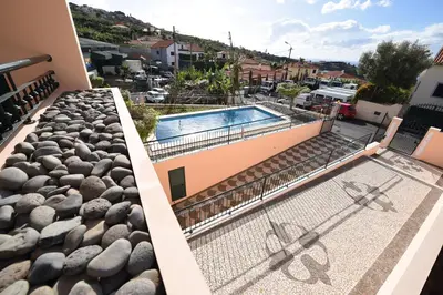 a swimming pool on the roof of a house at Villa Chaves in Funchal